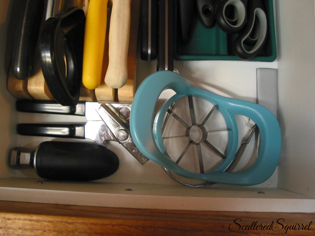 a few spare kitchen tools neatly contained in the front of the drawer