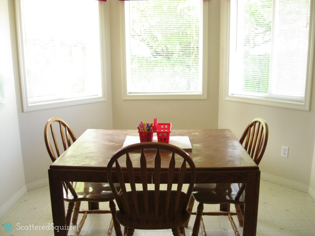 Clean and simple breakfast nook, with coloring supplies laid out on the table. ScatteredSquirrel.com