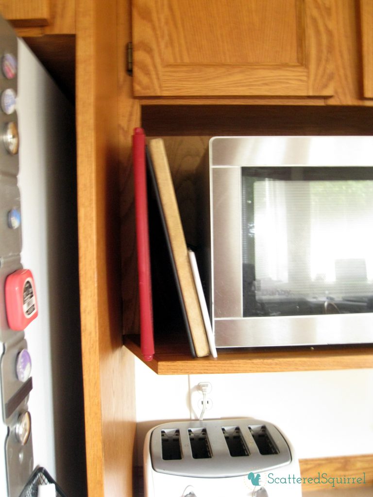 cutting boards stored beside the microwave from ScatteredSquirrel.com