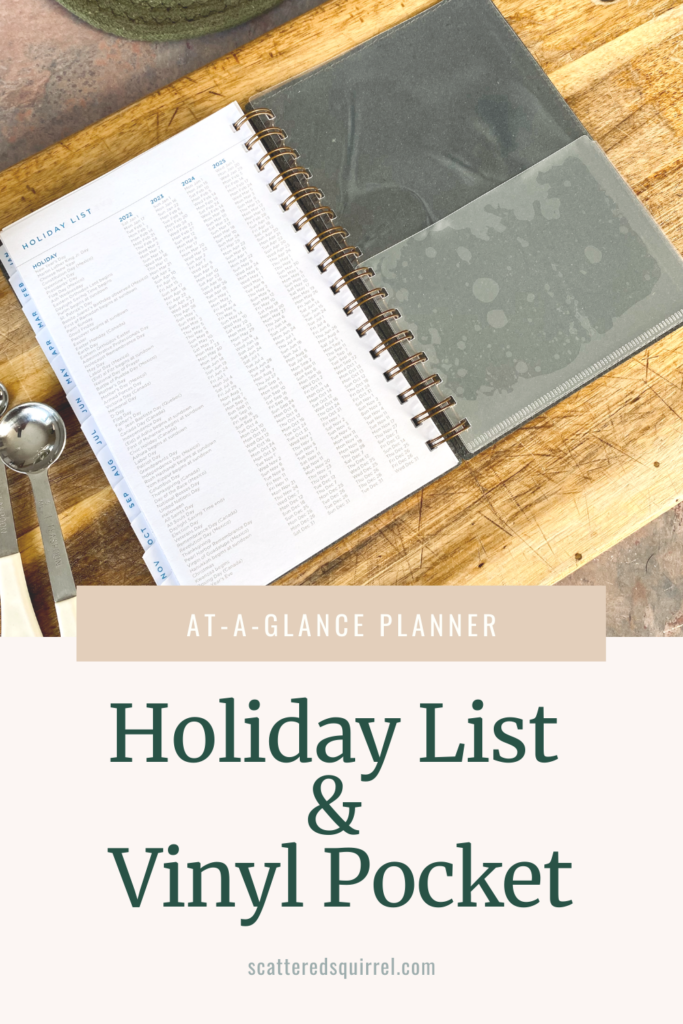 A planning lying open on a cutting board, showing the back cover on the right hand side with a vinyl pocket and then on the left is a list of holidays for the next 4 years.