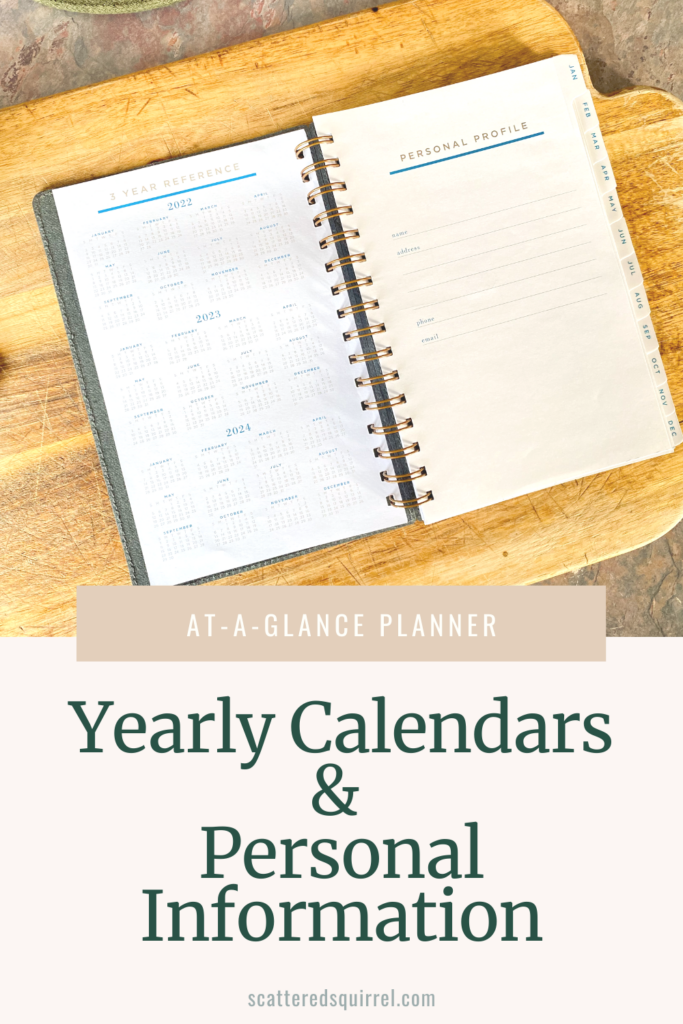 A planner lays open on a cutting board showing three yearly calendars on the left page and the right is a page for your personal profile.