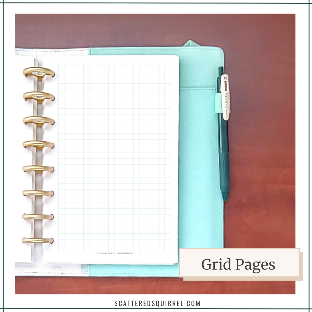 An auqa planner with gold disc binding shows a page covered in a grid for notes or memory keeping.