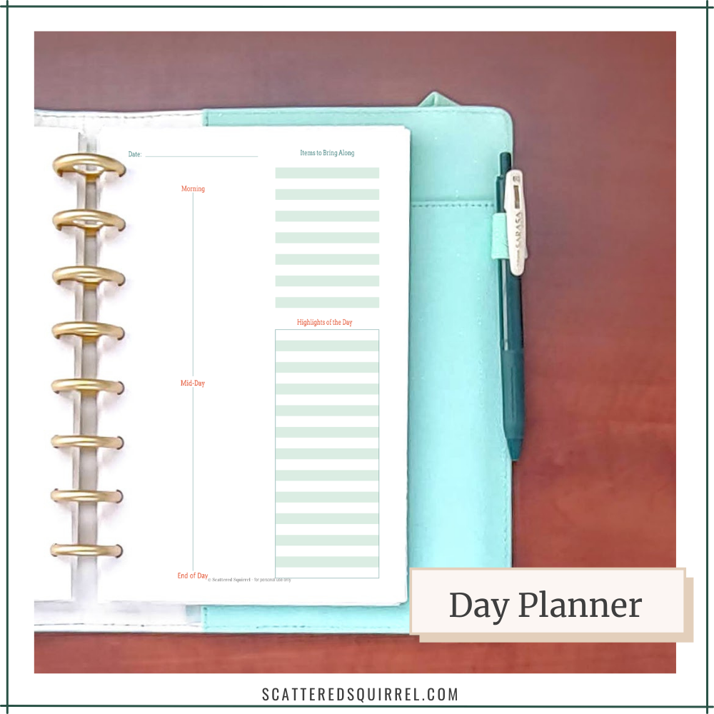 An auqa planner with gold disc binding shows a day planner page.