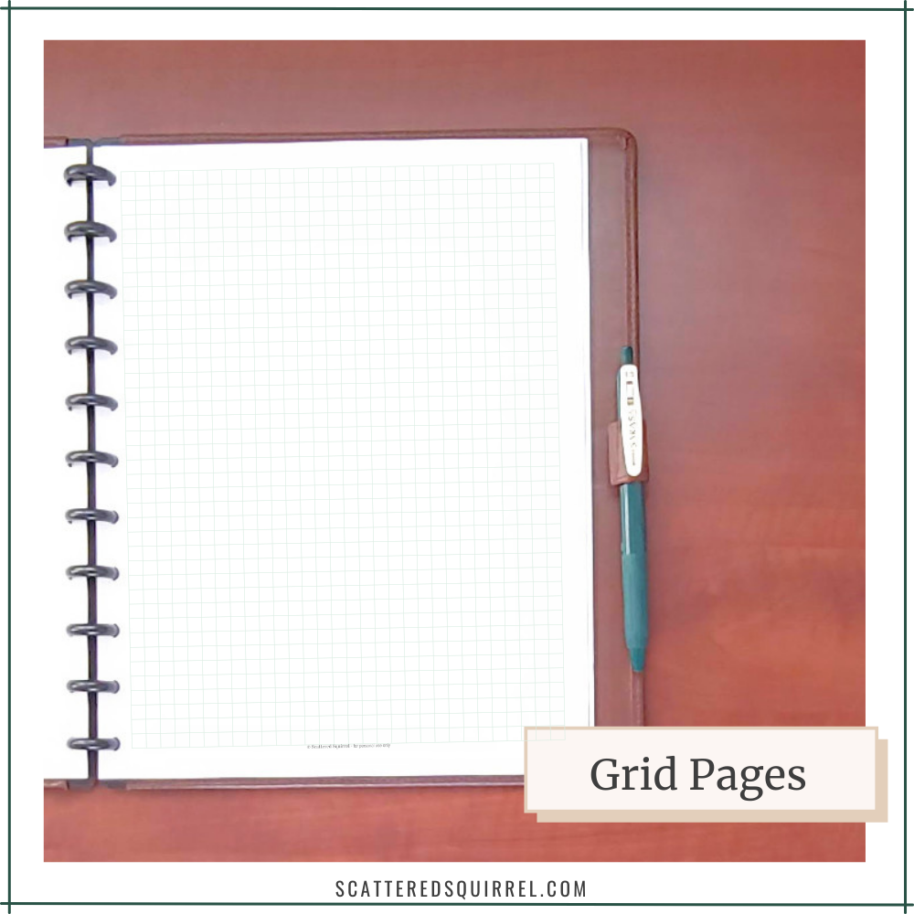 A brown planner with black disc binding shows a page of graph paper.