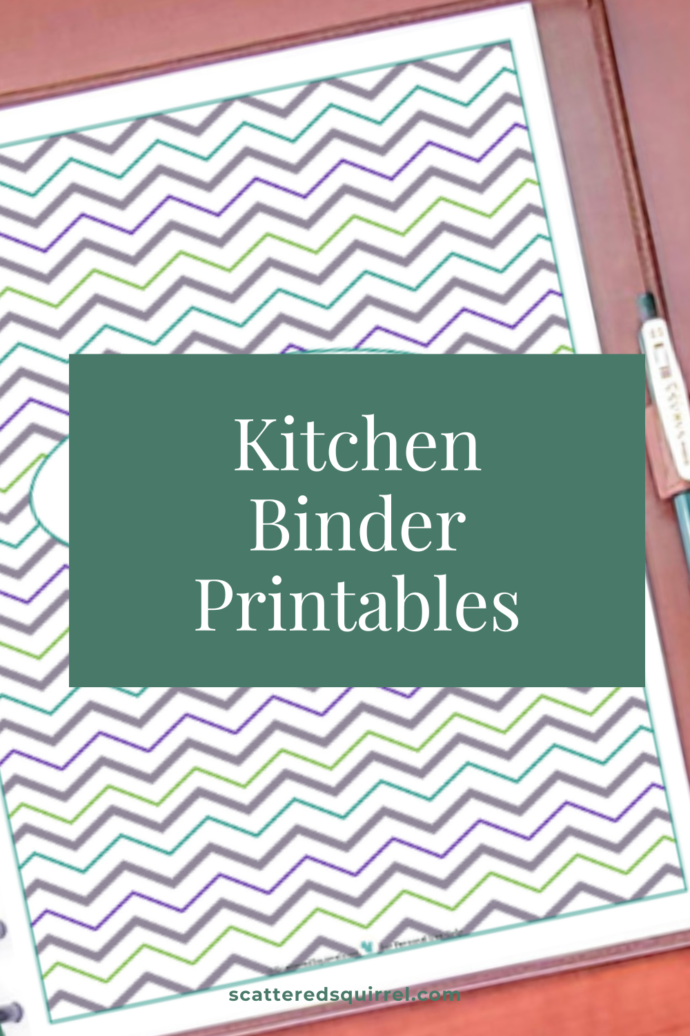 This is the feature image for the Kitchen Binder Printables page. It shows a planner lying open on a desk to a title page. Covering the center of the cover page is a green text box that says "Kitchen Binder Printables"
